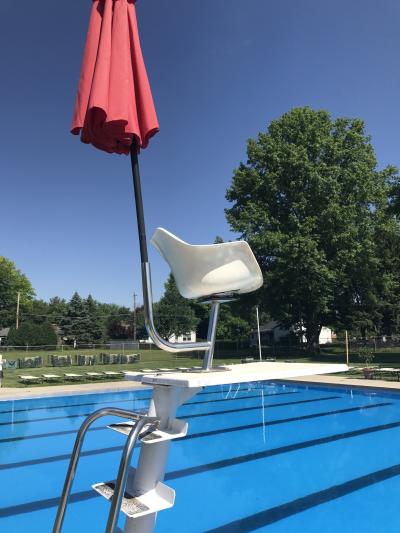 empty lifeguard chair and umbrella
